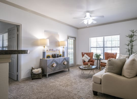 spacious living room with expansive windows at Stoneleigh on Spring Creek apartments