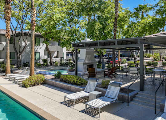 shaded, poolside lounging areas at Avora apartments