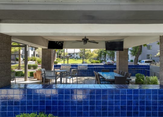 covered patio with grilling area and al fresco dining at Avora apartments