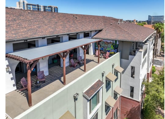 outdoor patio with covered lounging areas at Roosevelt Square apartments