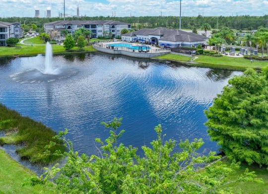 a view of a pond with a fountain in the middle