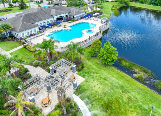 aerial view of the lake and swimming pool at The Reserves at Alafaya apartments