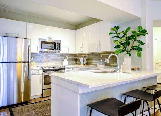 Luxury Kitchen with stainless steel appliances and quartz countertops at Sophia at Abacoa apartments
