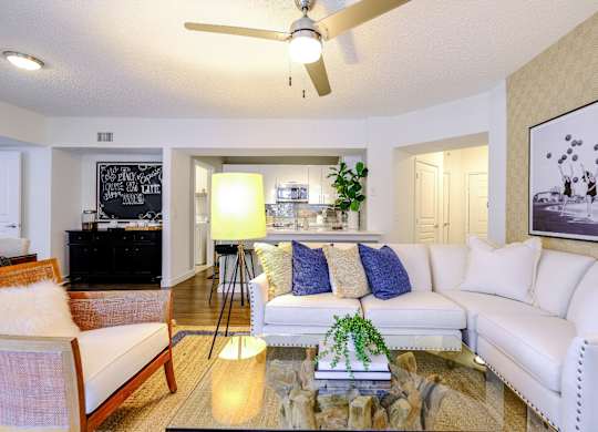 Spacious living area with hardwood-inspired floors and a ceiling fan at Sophia at Abacoa luxury Jupiter, FL apartments for rent