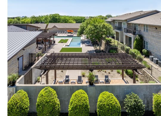 swimming pool and poolside lounging area at The Pradera apartments