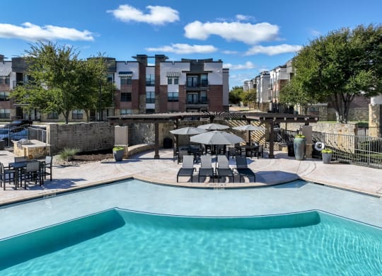 poolside lounging areas at Soho Parkway apartments