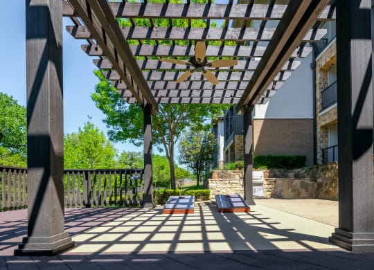 outdoor pergola social area with cornhole at Berkshire Medical District apartments