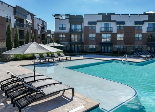 swimming pool with sun deck at Soho Parkway apartments