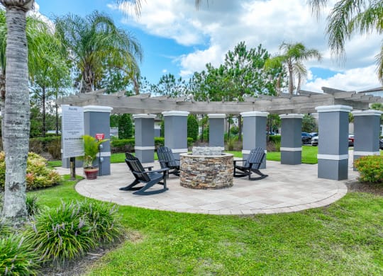 an outdoor patio with fireside lounging at The Reserves at Alafaya apartments