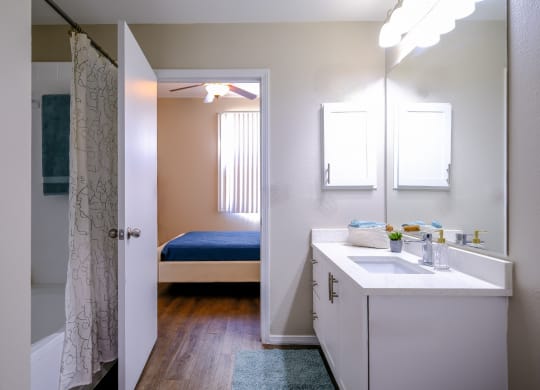 luxury bathroom with modern white cabinetry at Roosevelt Square apartments