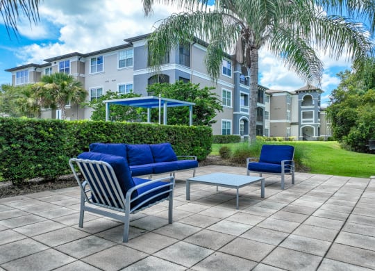 an outdoor patio and lounging area at The Reserves at Alafaya apartments