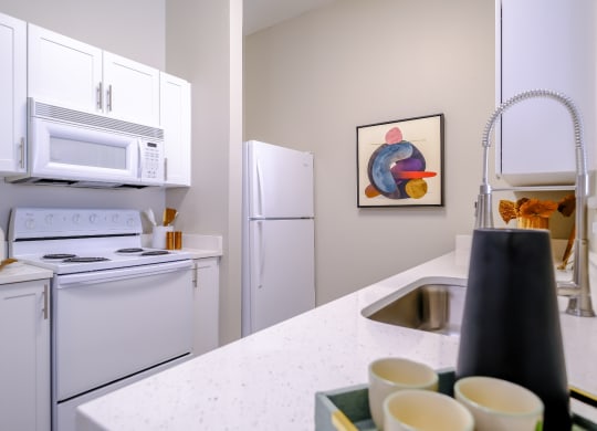 well appointed kitchen with modern white cabinetry at Roosevelt Square apartments in Phoenix
