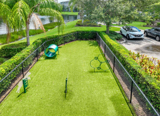 a backyard with a tennis court and tennis rackets