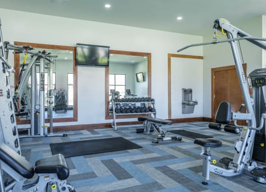 fitness center with free weights at The Pradera apartments