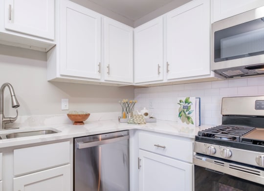 Heathermoor and Bedford Commons apartments kitchen with stainless steel appliances and white cabinets