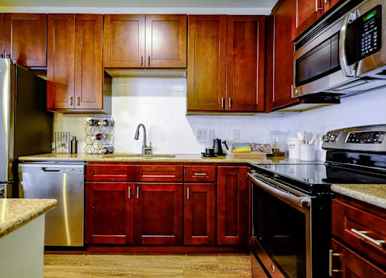 luxury kitchen with stainless steel appliances at Berkshire Village District apartments in Raleigh