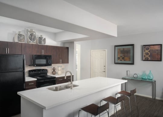 Brown cabinet kitchen with white countertops