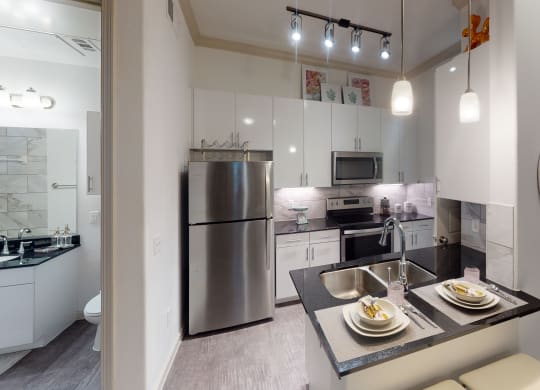 a kitchen with white cabinetry and stainless steel appliances