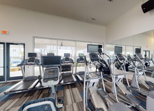 a room filled with lots of cardio equipment