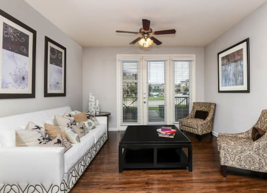 Soho Parkway apartments living room with ceiling fan and hardwood-inspired flooring
