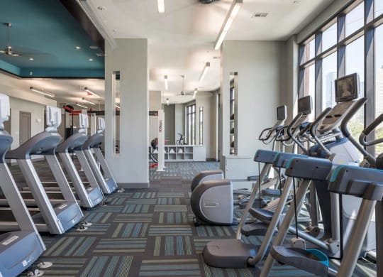 a fitness center with cardio equipment at Tinsley on the Park apartments