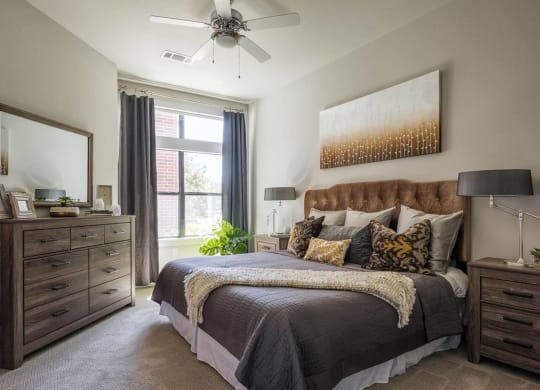 spacious bedroom with a ceiling fan at Tinsley on the Park apartments