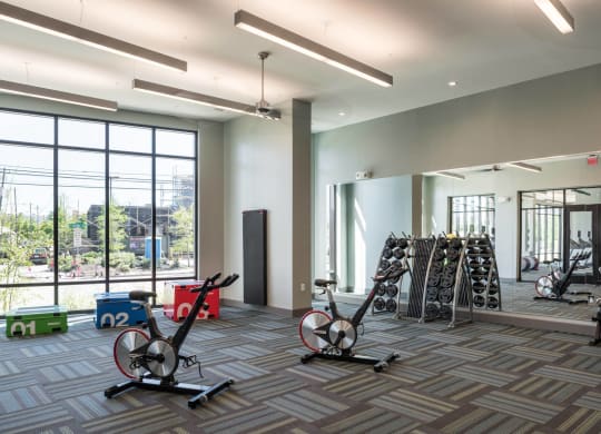 a gym with weights at Tinsley on the Park apartments