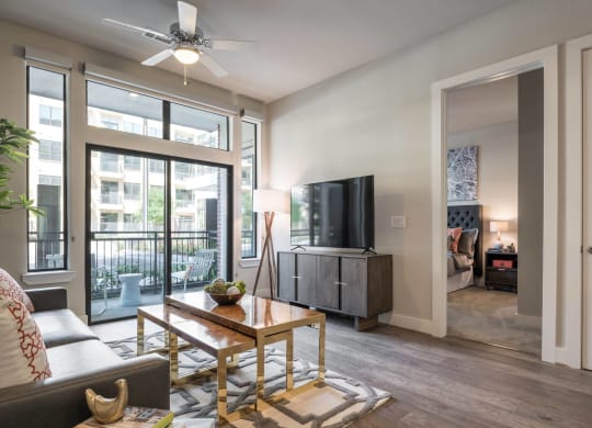 a living room with expansive windows at Tinsley on the Park apartments