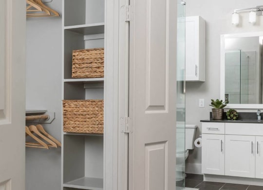 a bathroom and closet with shelving at Tinsley on the Park apartments