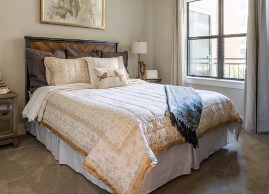 spacious bedroom with a ceiling fan at Tinsley on the Park apartments