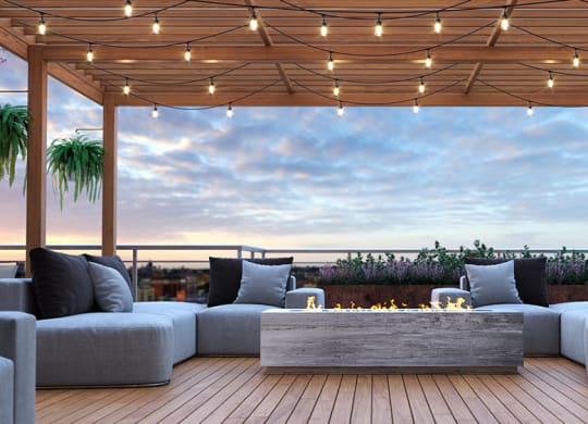 a roof terrace with couches and a fireplace at Tribeca NOMA apartments