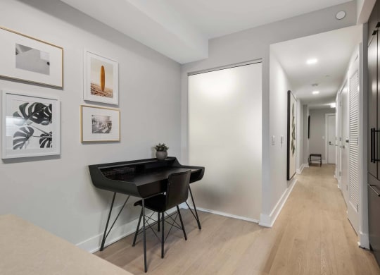 a home office with a black desk and chair at Tribeca NOMA apartments