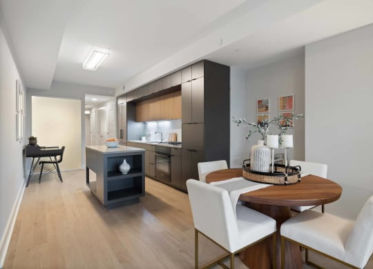 A kitchen and dining room with black cabinets and a black desk at Tribeca NOMA apartments