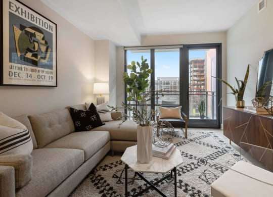 A living room with a large window with a view at Tribeca NOMA apartments