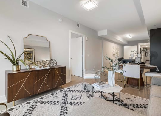 a living room with white walls and a mirror at Tribeca NOMA apartments