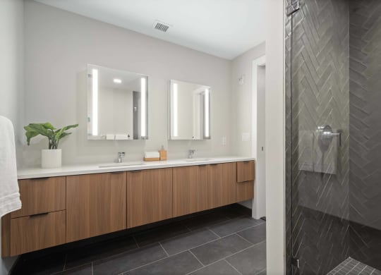a large bathroom with two sinks and a shower at Tribeca NOMA apartments