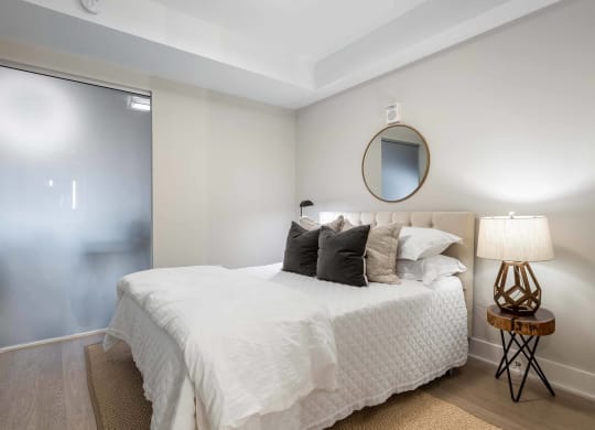a bedroom with a sliding glass door at Tribeca NOMA apartments