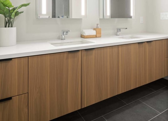 a bathroom with two sinks and two mirrors at Tribeca NOMA apartments
