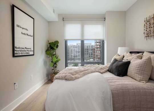 a bedroom with large windows and a view at Tribeca NOMA apartments