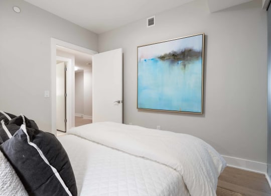 a bedroom with a large painting at Tribeca NOMA apartments