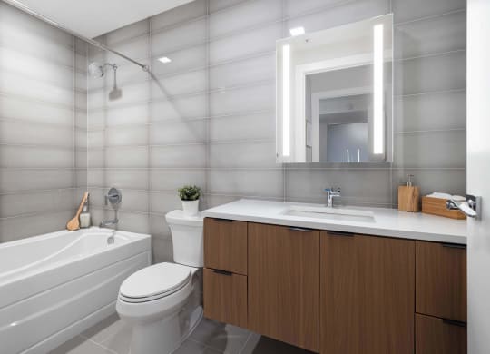 a bathroom with a toilet shower and sink at Tribeca NOMA apartments