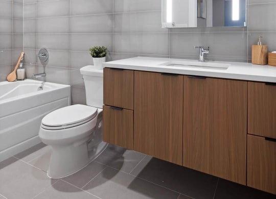 a bathroom with a toilet sink and shower in Tribeca NOMA apartments