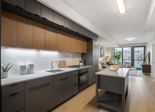 a kitchen with wooden cabinets and a white countertop in Tribeca NOMA apartments