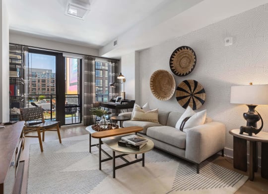 a living room with a couch and a balcony at Tribeca NOMA apartments