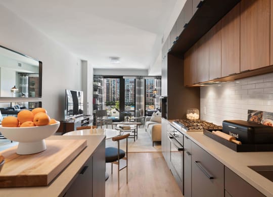 Kitchen overlooking a living room and terrace at Tribeca NOMA apartments