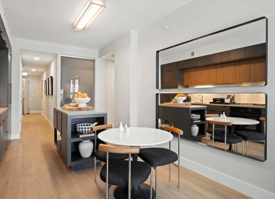 a kitchen and dining room with large wall mirrors at Tribeca NOMA apartments