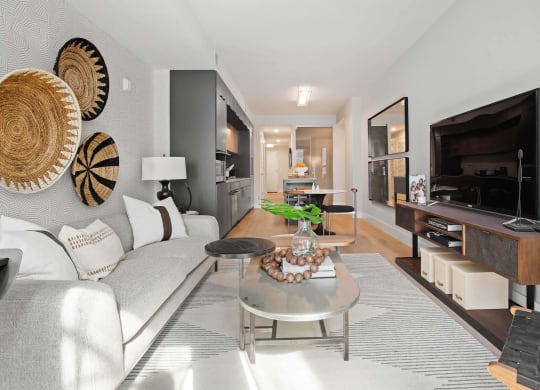 a living room with a couch table and TV at Tribeca NOMA apartments