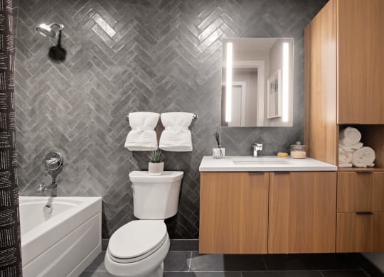a bathroom with a toilet and a sink and a bath tub at Tribeca NOMA apartments