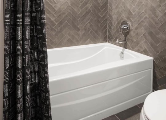 a bathroom with a tub and a shower at Tribeca NOMA apartments