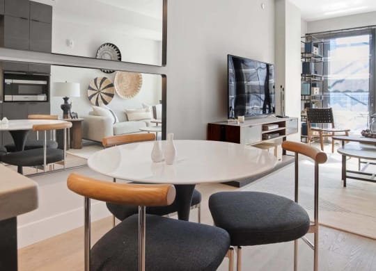 a dining room and living room with a table and chairs at Tribeca NOMA apartments